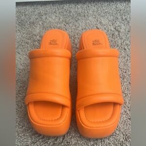 Orange platform heels.